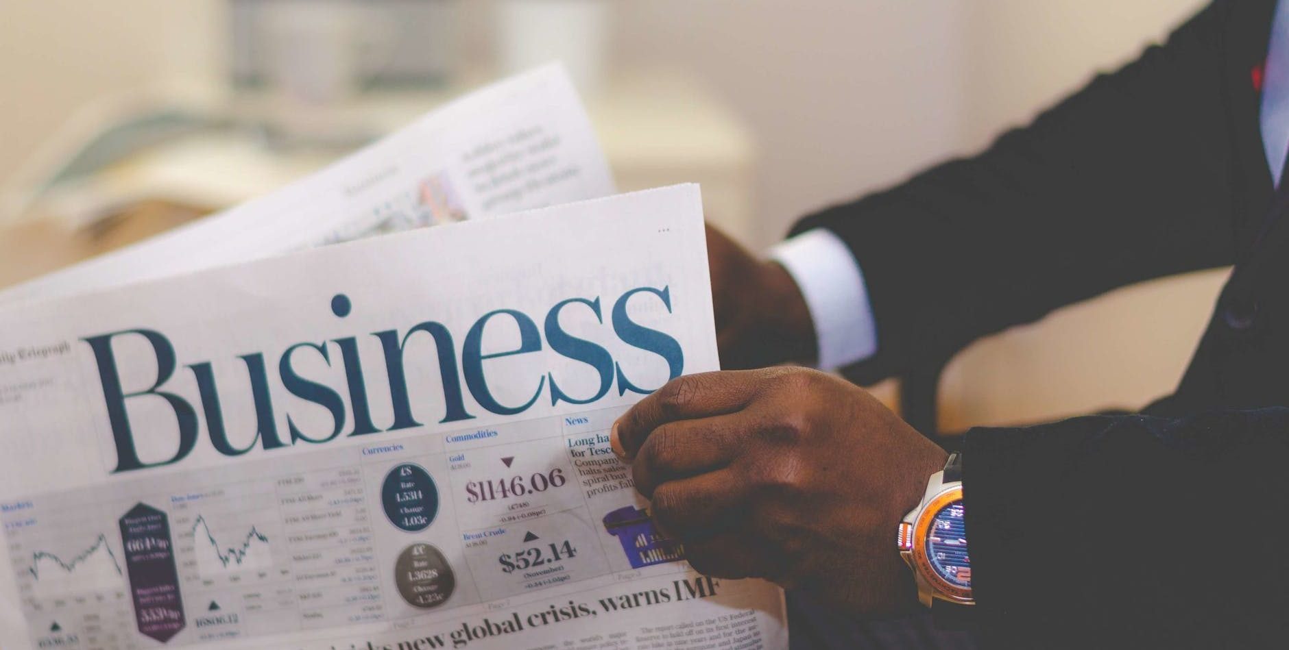 person holding white and blue business paper