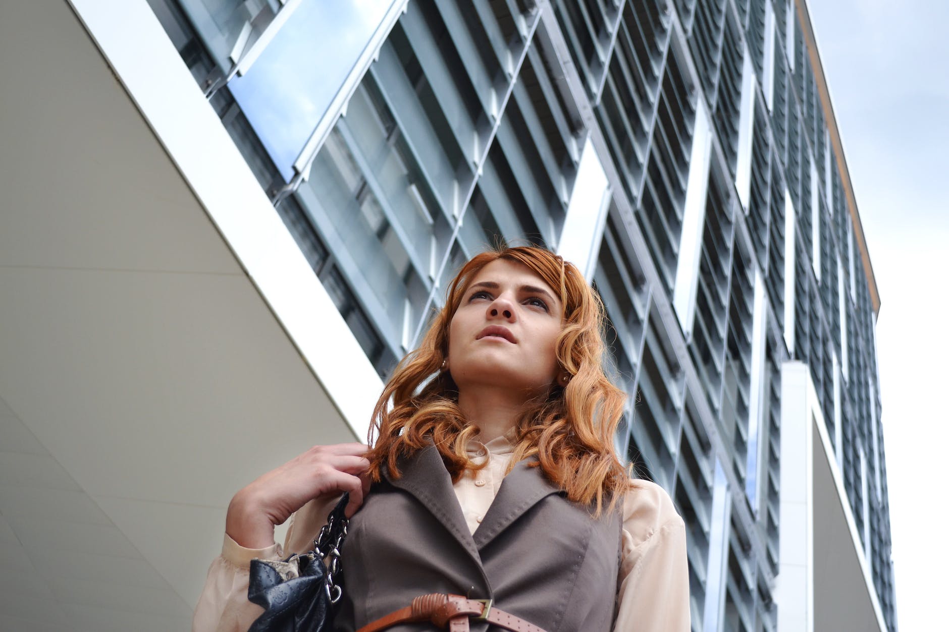 woman looking at modern office building