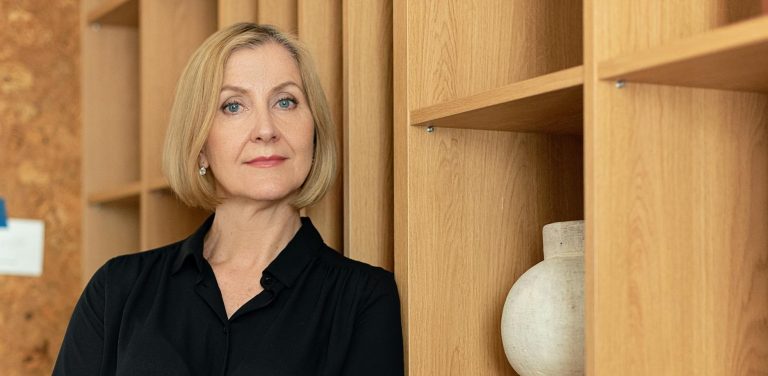 a woman leaning on a shelf